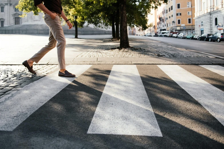 a man walking across a crosswalk on a city street, trending on unsplash, square lines, fan favorite, sustainable materials, spanish