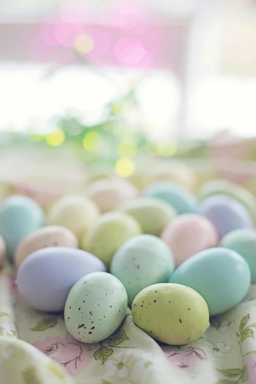 a bunch of eggs sitting on top of a table, in pastel shades, upclose, cheery, festive