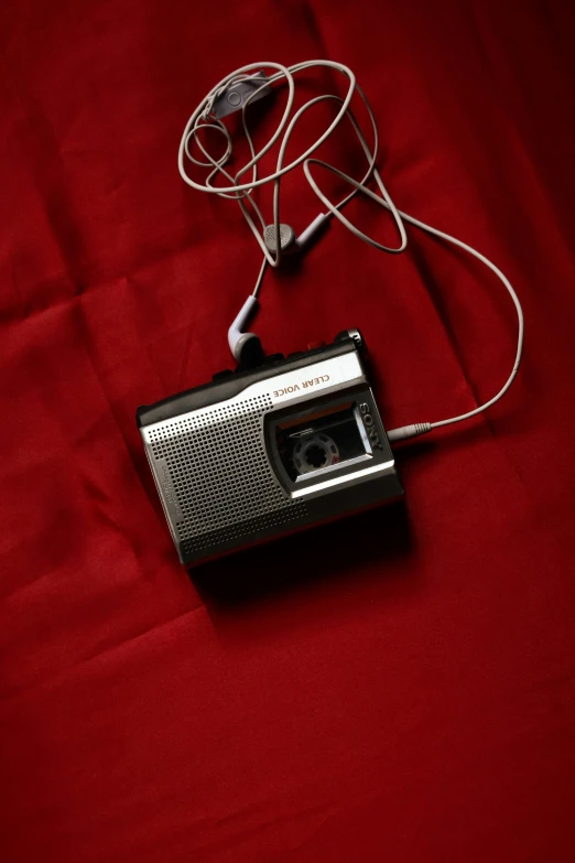 a radio sitting on top of a red sheet, by Yasushi Sugiyama, unsplash, kodak brownie camera, cords, high resolution, under a spotlight