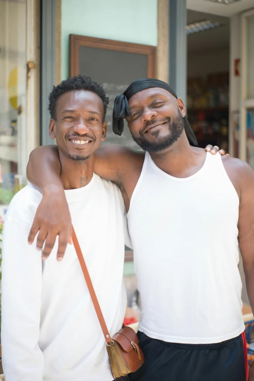 a couple of men standing next to each other, brown skinned, photo for a store, prideful, neighborhood