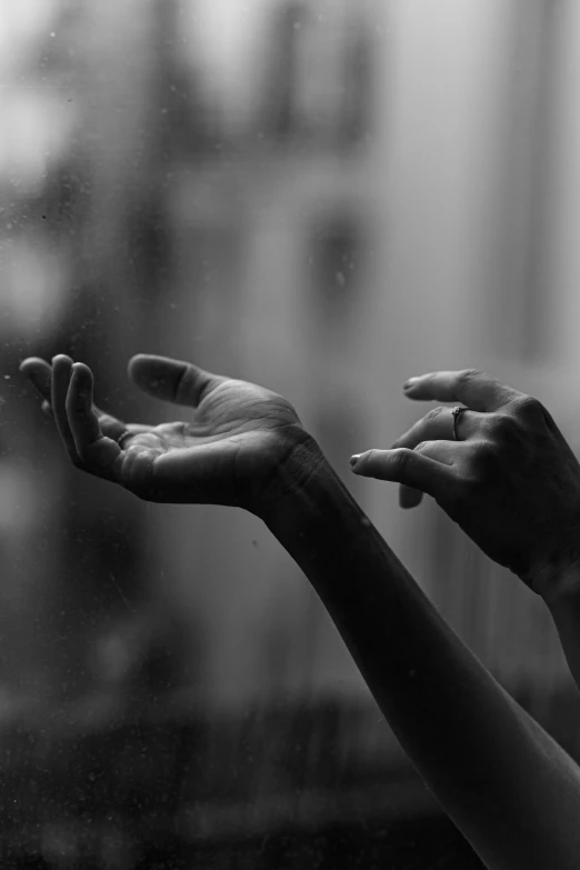 a black and white photo of two hands reaching out of a window, by Alexis Grimou, on a rainy day, anjali mudra, music instrument in hand, dayanita singh