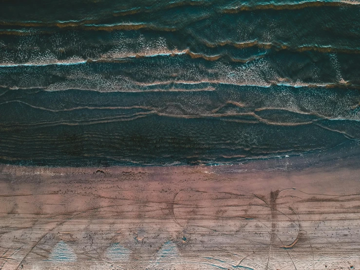 a couple of surfboards sitting on top of a sandy beach, an album cover, by Lee Loughridge, pexels contest winner, graffiti, aerial iridecent veins, geological strata, view from above, brown mud
