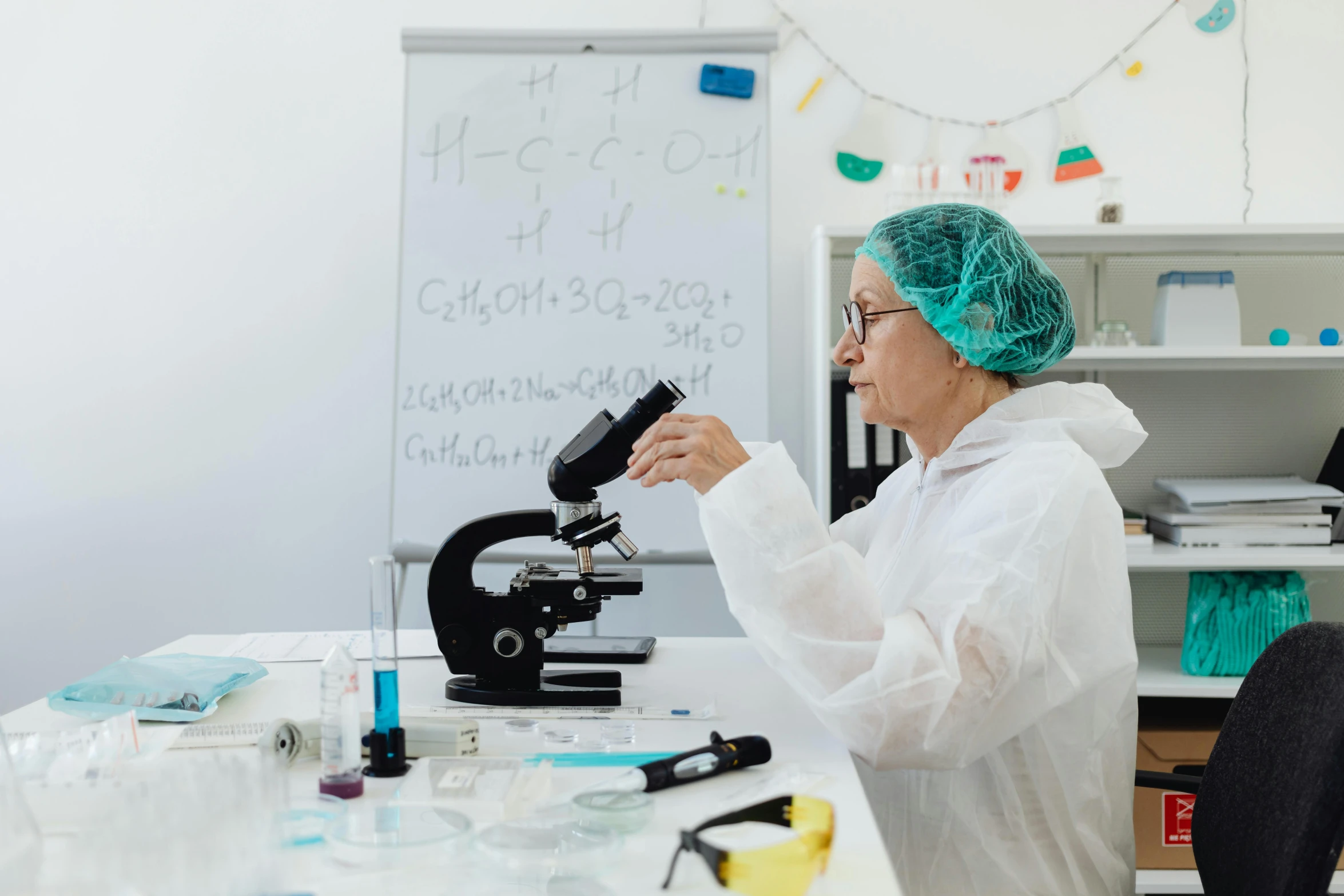 a woman in a lab coat looking through a microscope, pexels contest winner, decoration, older woman, low quality photo, background image