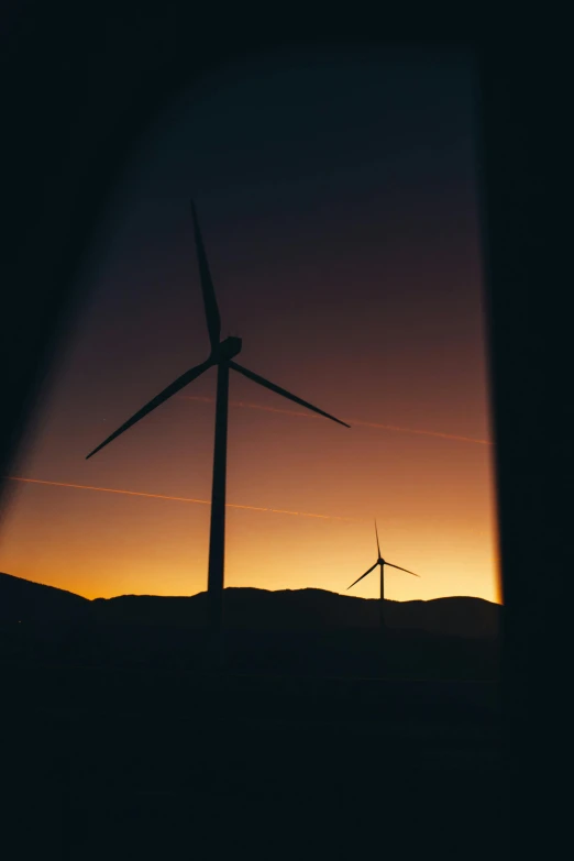 a couple of wind turbines sitting on top of a hill, a picture, pexels contest winner, low light cinematic, near a window window, cinematic shot ar 9:16 -n 6 -g, best photo