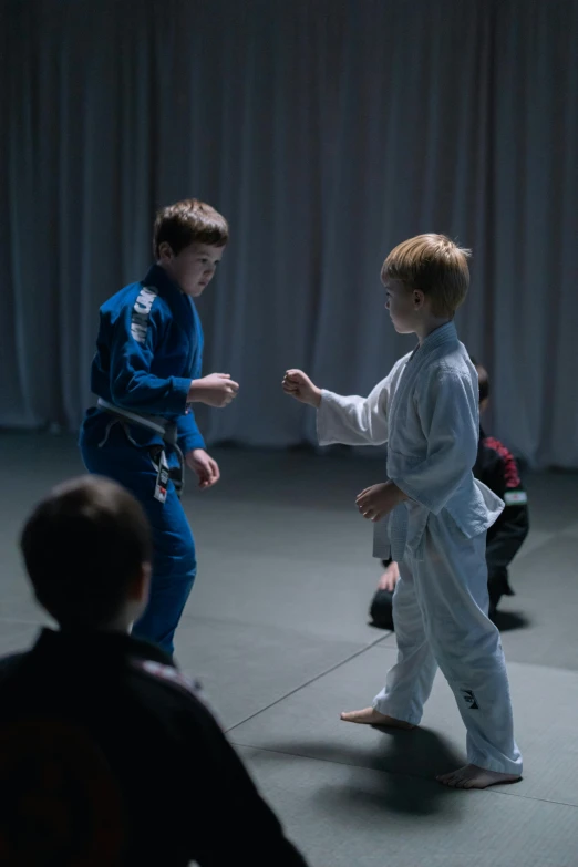 a couple of kids that are standing in a room, by Jacob Toorenvliet, happening, sparring, slate, mid night, medium closeup