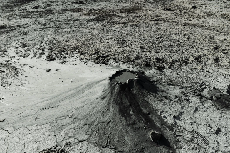 a black and white photo of a tree stump, by Vija Celmins, unsplash, land art, flowing lava and ash piles, on the surface of the moon, brown mud, ignant