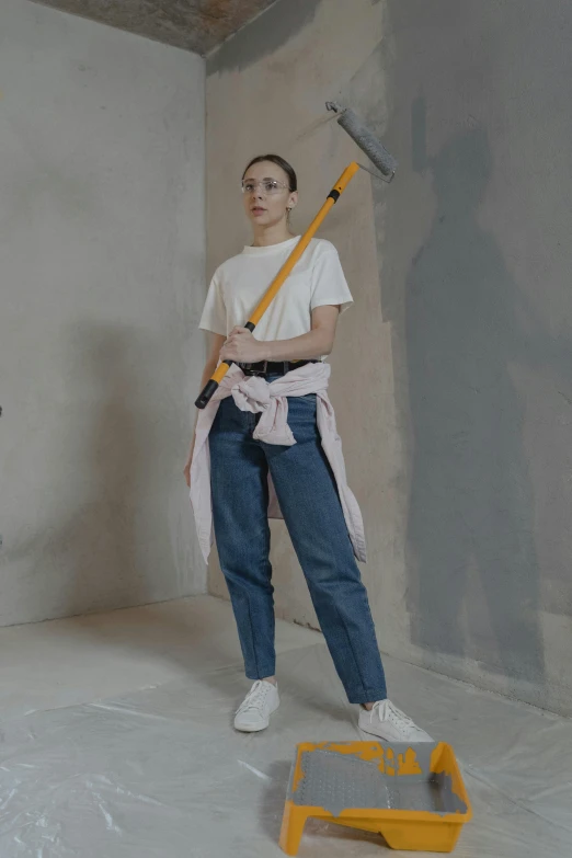 a couple of people that are standing in a room, holding a paintbrush, white shirt and blue jeans, hero action pose, dasha taran