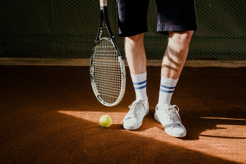 a man standing on top of a tennis court holding a racquet, pexels contest winner, striped socks, hard clay, a pair of ribbed, with a long white