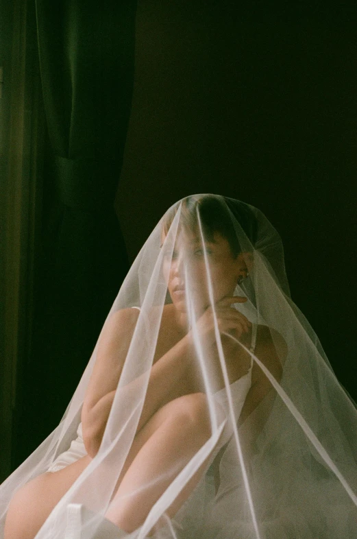 a woman sitting on top of a bed covered in a white veil, inspired by Elsa Bleda, unsplash contest winner, renaissance, ignant, non binary model, cindy avelino, still from a music video