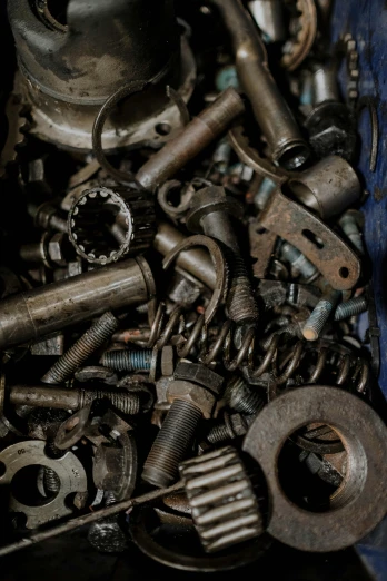 a box filled with lots of different types of tools, by David Simpson, unsplash, assemblage, mining scrap metal, closeup of car engine, bolts, ancient keys