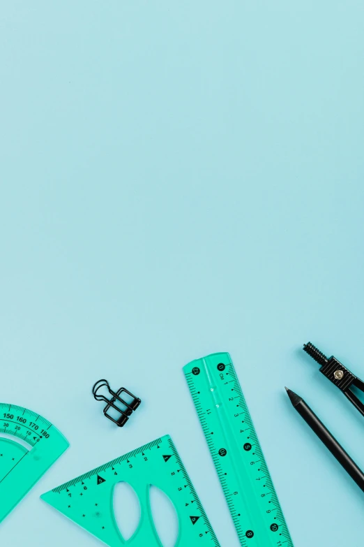 a variety of school supplies laid out on a blue surface, a picture, trending on pexels, architectural scale, black and teal paper, thumbnail, profile pic