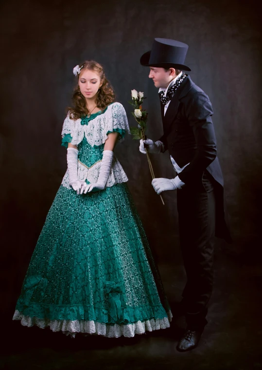 a man standing next to a woman in a green dress, a colorized photo, inspired by Ivan Kramskoi, romanticism, high quality theatre costume, dressed in a frilly ((lace)), production photo, lady with glowing flowers dress