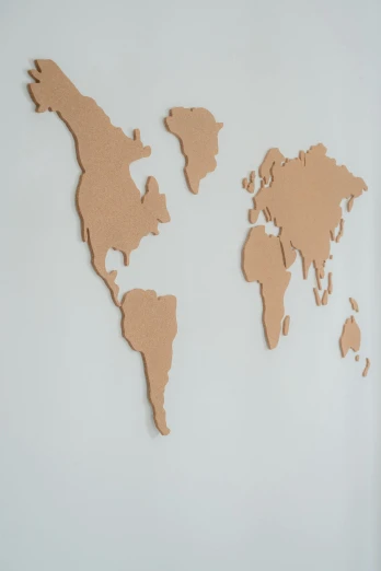 a map of the world on a wall, made of cardboard, detailed product shot, close up shot from the side, outline