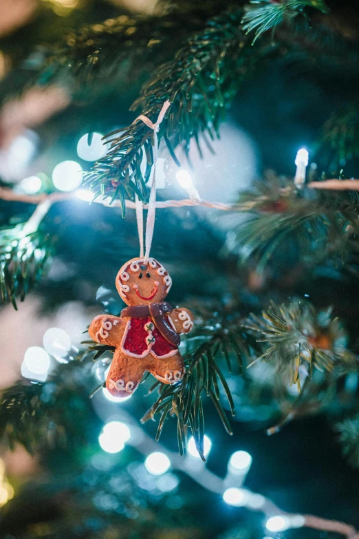 a close up of a christmas ornament on a tree, by Julia Pishtar, pexels, gingerbread people, natural lights, thumbnail, multiple stories