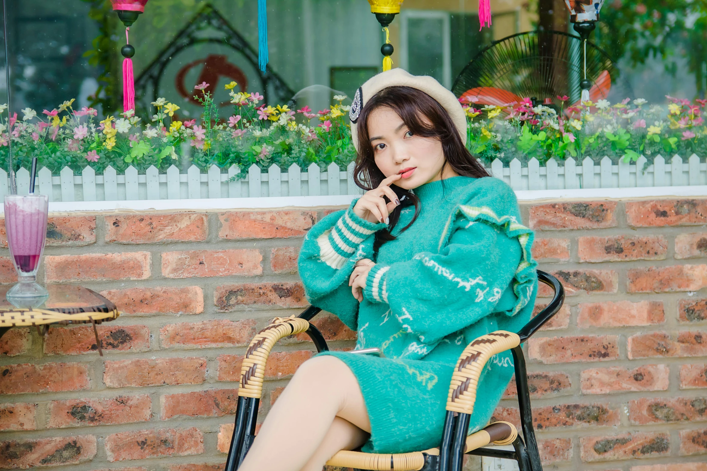 a woman sitting in a chair talking on a cell phone, inspired by Kim Jeong-hui, instagram, wearing a green sweater, ulzzang, fashion pose, portrait image