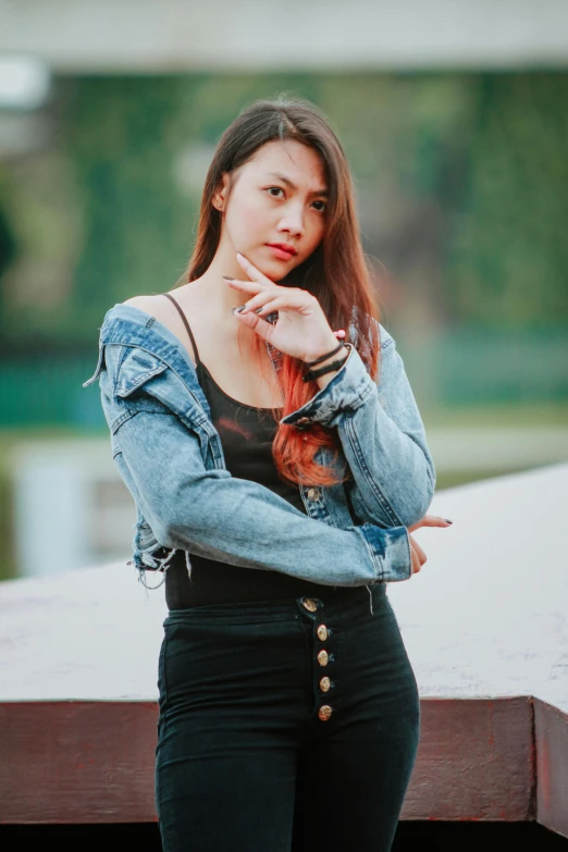 a woman standing on top of a wooden platform, an album cover, trending on pexels, realism, denim jacket, beautiful young asian woman, 15081959 21121991 01012000 4k, wearing black camisole outfit