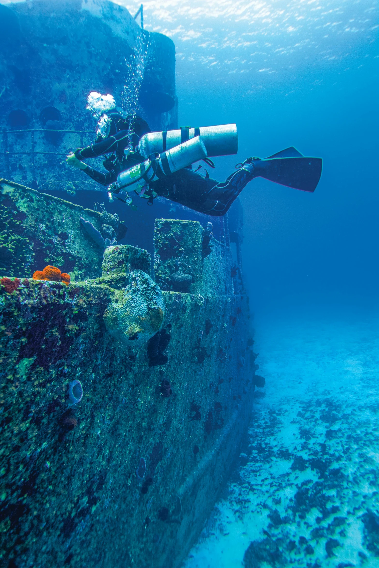 a person that is diving in the water, shipwrecks, o'neill cylinder colony, sapphire waters below, exterior shot