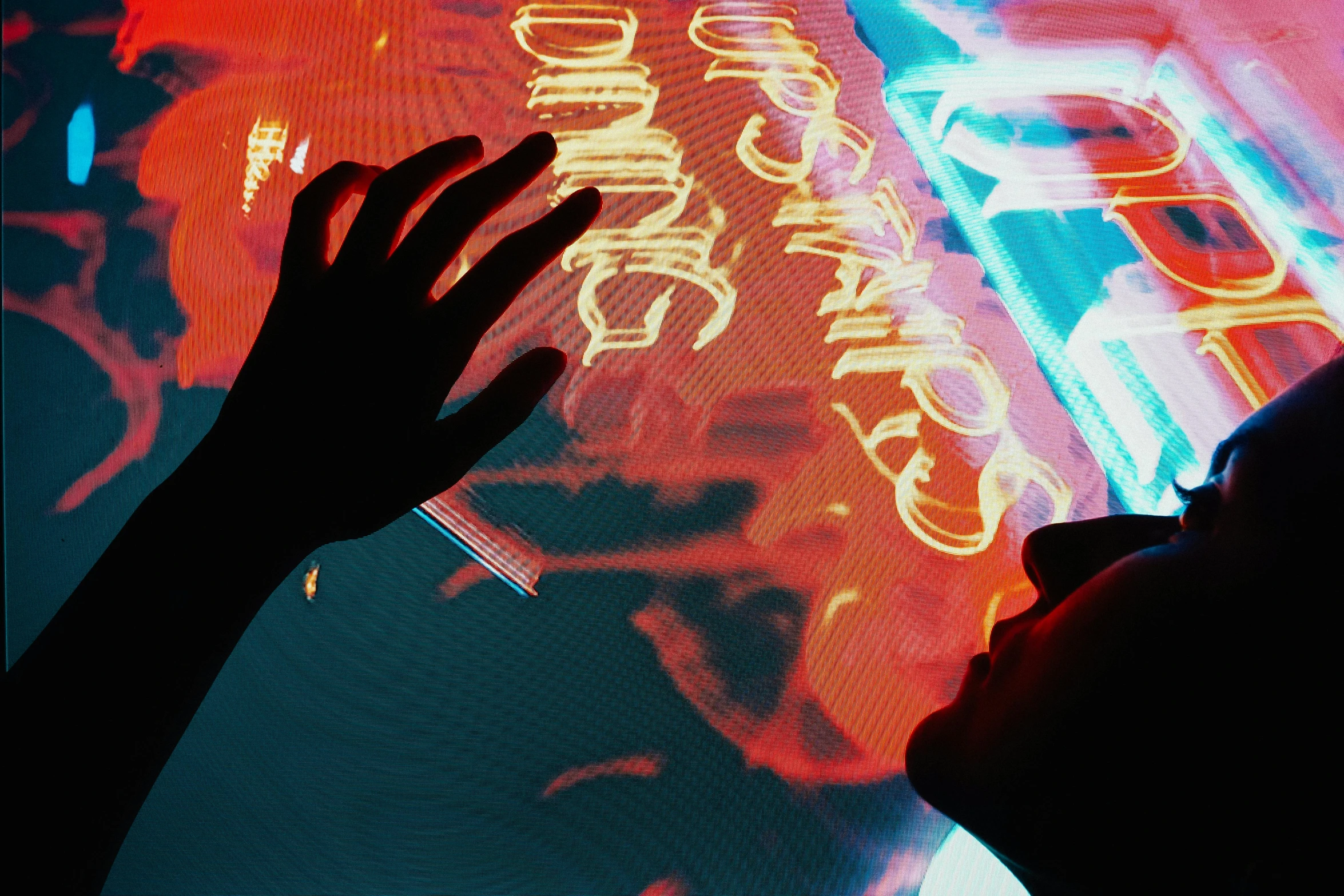 a person standing in front of a neon sign, pexels contest winner, interactive art, hands reaching for her, seen from below, synesthesia, neo noir