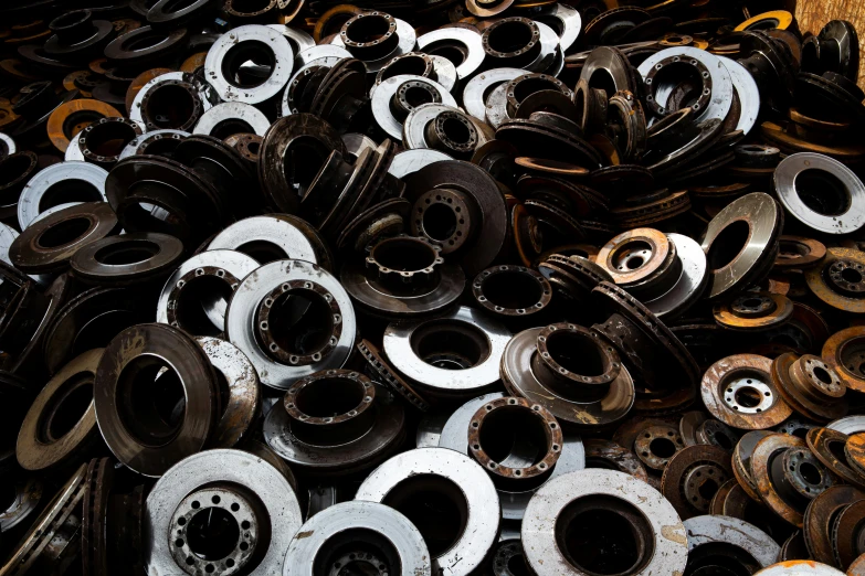 a pile of metal parts sitting on top of a table, unsplash, portholes, spiralling, jdm, organic steel