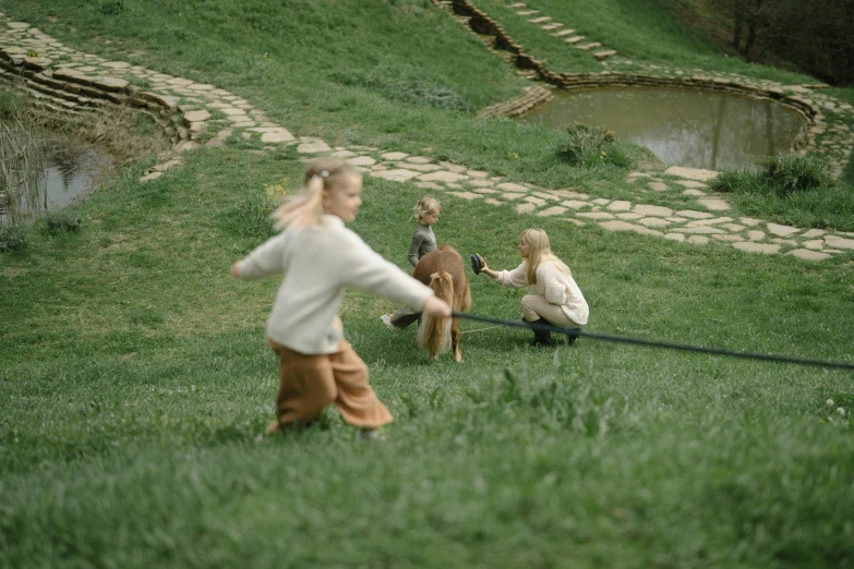 a group of children playing a game of frisbee, an album cover, by Emma Andijewska, pexels contest winner, land art, slavic folk fairytale, still from film, ignant, mini model