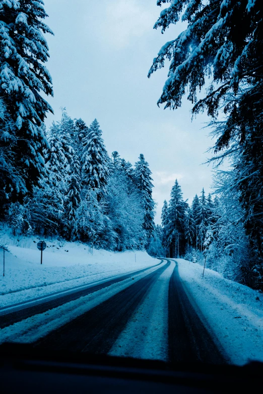 a car driving down a snow covered road, black forest, paved roads, thumbnail