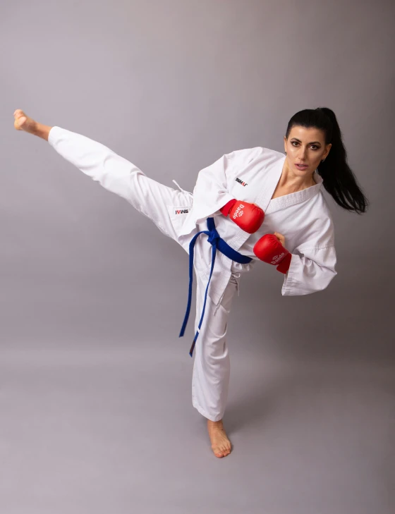 a woman in a white kimono doing a kick, sigma 55”, red and blue garments, hero pose, square