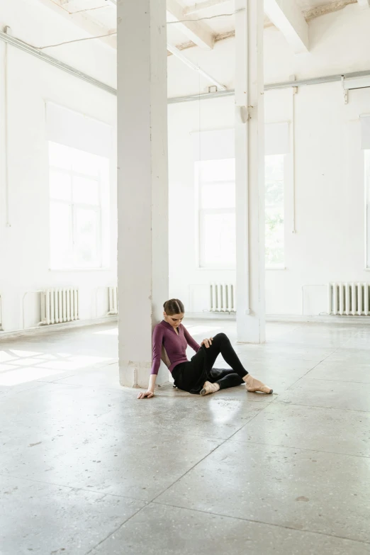 a woman sitting on the floor in an empty room, by Elizabeth Polunin, unsplash, light and space, olga zakharova, tall ceilings, on a pale background, 15081959 21121991 01012000 4k