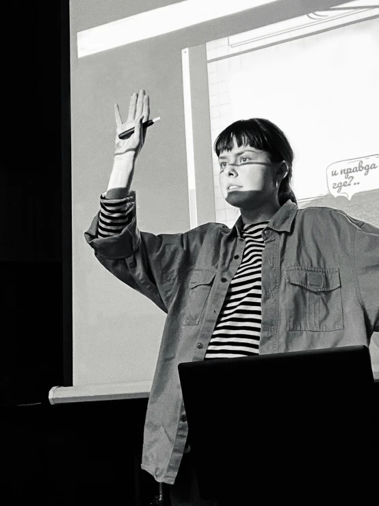 a black and white photo of a woman giving a presentation, by Emma Geary, academic art, raised hand, andy milonakis, russian academic, cartoonist