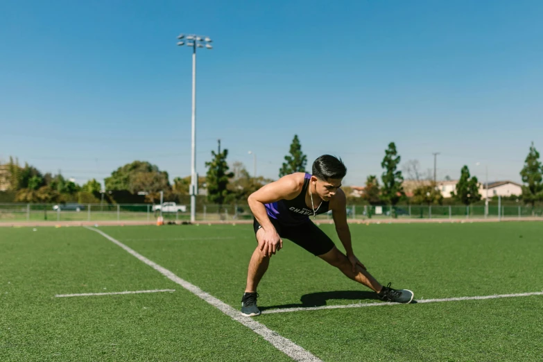 a man standing on top of a tennis court holding a racquet, by Carey Morris, pexels contest winner, stretching her legs on the grass, athletic crossfit build, profile image, asian male