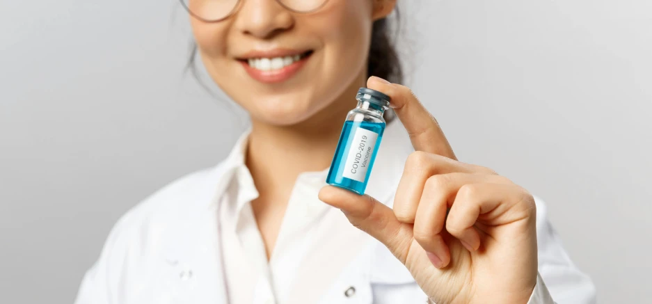 a close up of a person holding a bottle of liquid, inspired by Évariste Vital Luminais, portrait of a female pathologist, cerulean blue, thumbnail, formulas