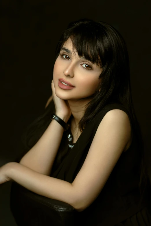 a woman in a black dress posing for a picture, an album cover, inspired by Taravat Jalali Farahani, headshot profile picture, casual pose, promo image, slight smirk