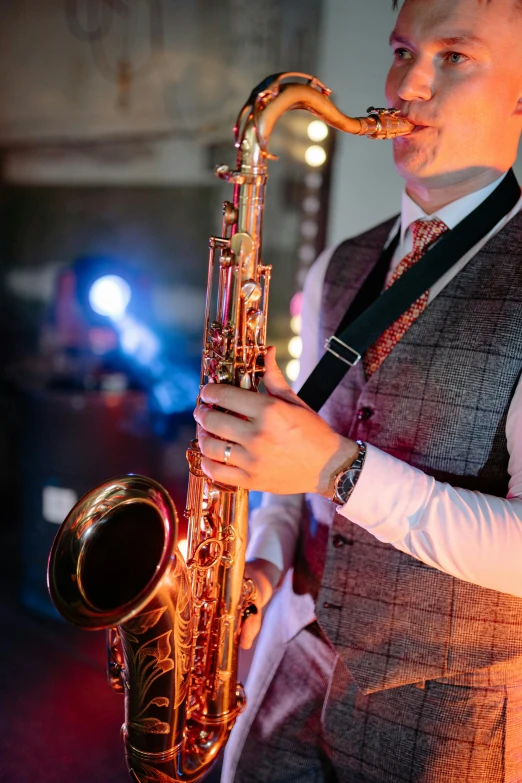 a man in a vest and tie playing a saxophone, trending on pexels, art nouveau, dj at a party, 15081959 21121991 01012000 4k, beautifully soft lit, wearing presidential band