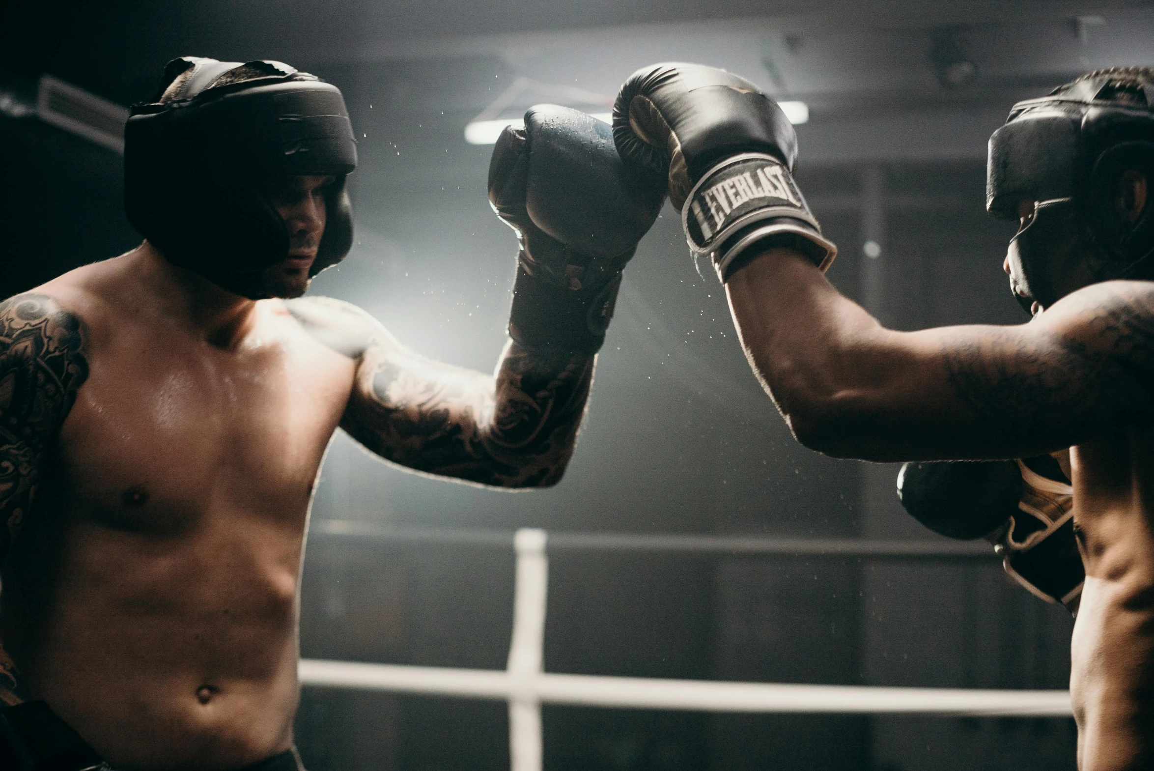 a couple of men standing next to each other in a boxing ring, pexels contest winner, holding it out to the camera, liam brazier, manuka, light and dark
