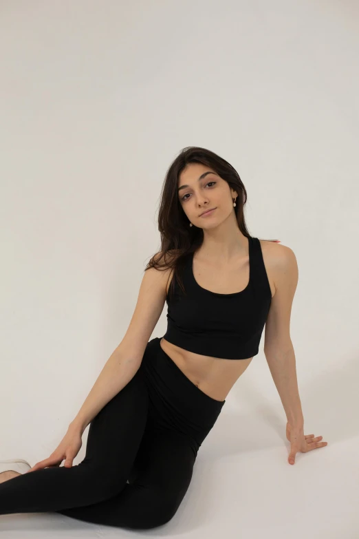 a woman in a black top and black leggings, wearing a crop top, full product shot, photograph taken in 2 0 2 0, hero pose