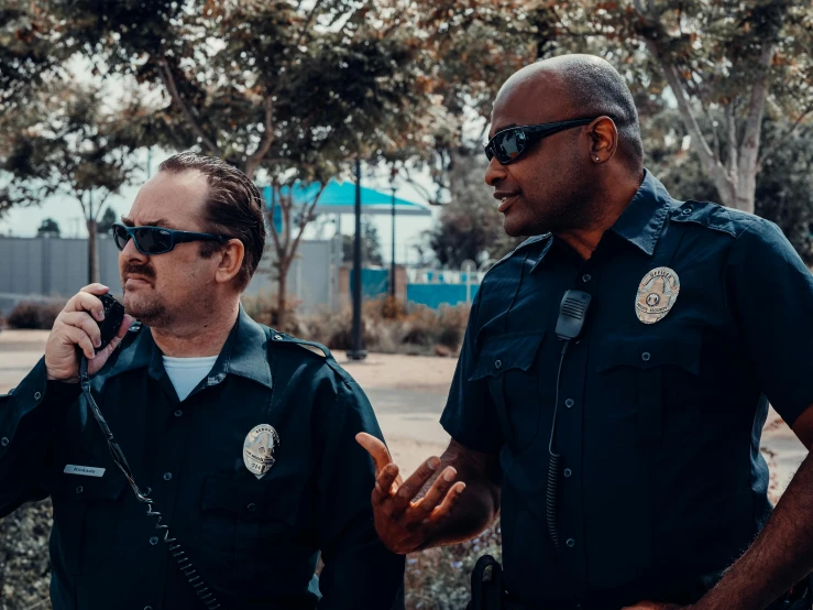 a couple of men standing next to each other, by Carey Morris, pexels, police officers, avatar image, los angelos, movie footage