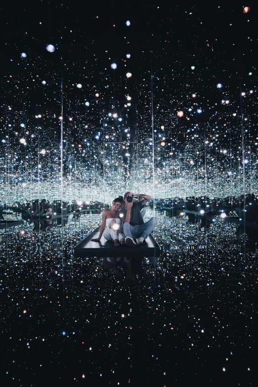 a group of people sitting on top of a boat, a hologram, by Kusama, unsplash contest winner, interactive art, glittering stars scattered about, reflective floor, black mirror series, 2 people