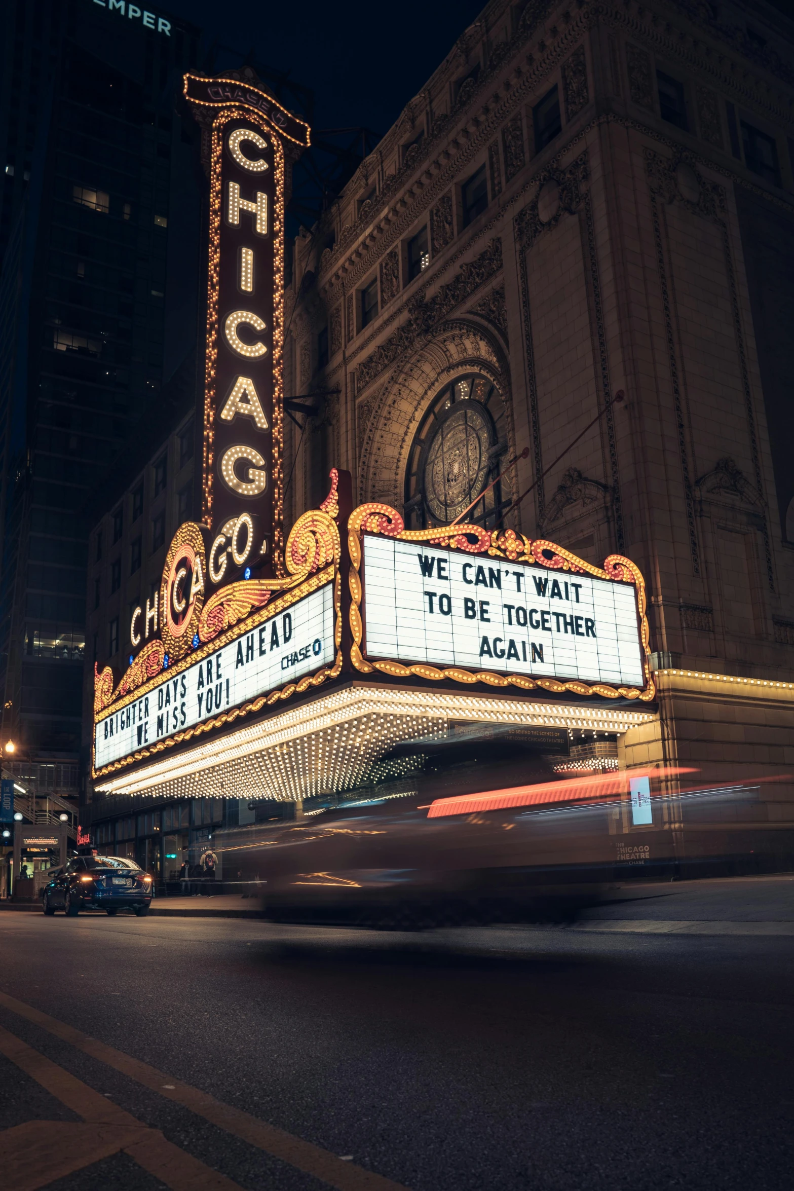 the chicago theater marquee is lit up at night, unsplash contest winner, 'if all can begin again, [ theatrical ], vhs footage of a movie set, 2000s photo