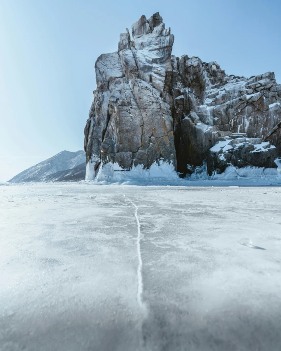 a large rock in the middle of a frozen lake, pexels contest winner, near lake baikal, thin straight lines, thumbnail, white lava