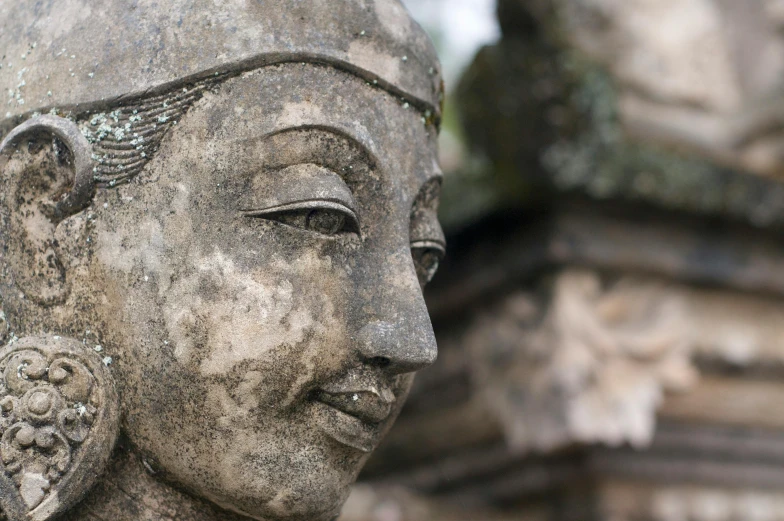 a close up of a statue of a woman, inspired by Li Di, unsplash, concrete art, at borobudur, portrait of monk, weathered artifacts, ancient”