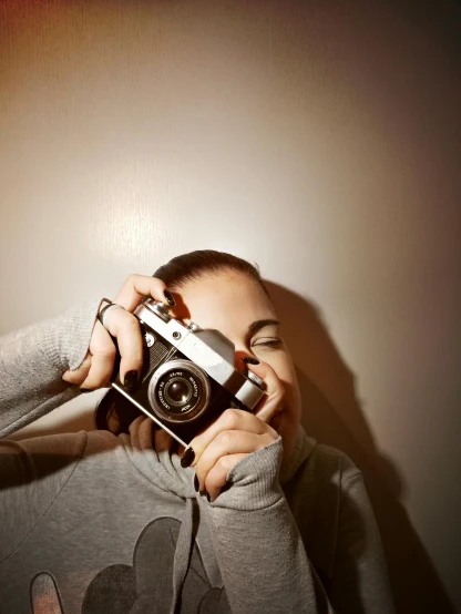 a woman taking a picture with a camera, inspired by Elsa Bleda, low colour, college, photography )