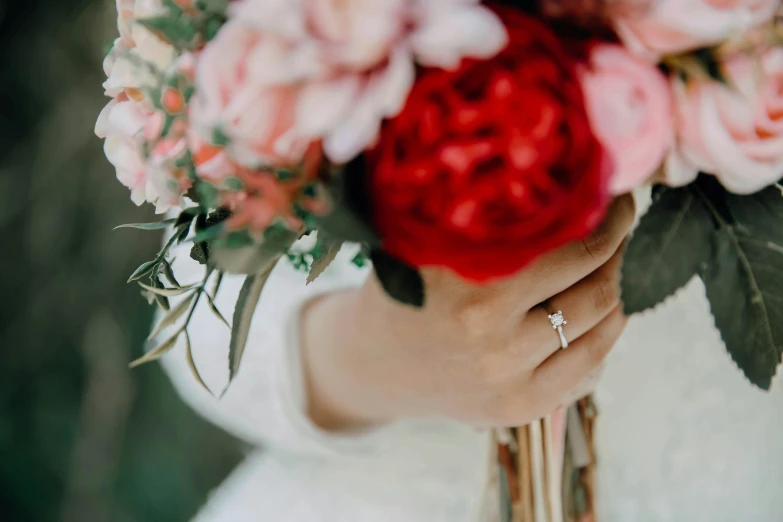 a close up of a person holding a bouquet of flowers, silver white gold red details, pink and pink details, zoomed out shot, colour corrected