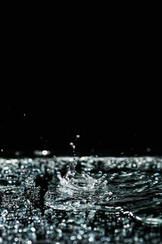 water splashing on the surface of a body of water, by Jacob Toorenvliet, hyperreal highly detailed 8 k, black!!!!! background, **cinematic, (night)