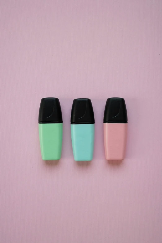 three different shades of lipstick on a pink background, unsplash, seafoam green, silicone cover, sprays, black and aqua colors