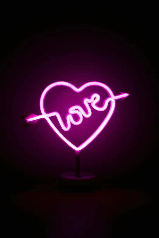 a neon sign that says love with an arrow in the shape of a heart, a picture, by Robbie Trevino, pexels, romanticism, glass sculpture of a heart, magenta, lovecratftian horror, hey