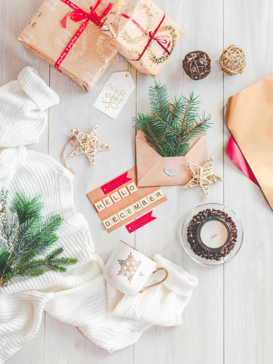 a pile of presents sitting on top of a wooden table, by Julia Pishtar, pexels contest winner, brown and cream color scheme, knolling, evergreen branches, instagram picture