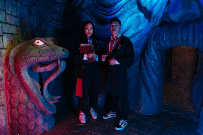 a couple of people standing next to each other, wizard themed, underground room, jordan grimmer and natasha tan, tentacle