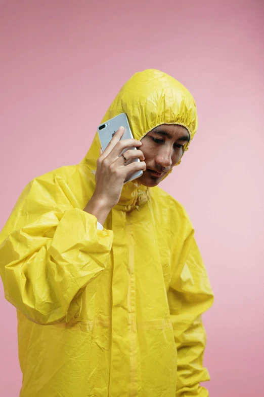 a man in a yellow rain suit talking on a cell phone, trending on pexels, hyperrealism, karim rashid, tyler the creator, unhappy, girl making a phone call