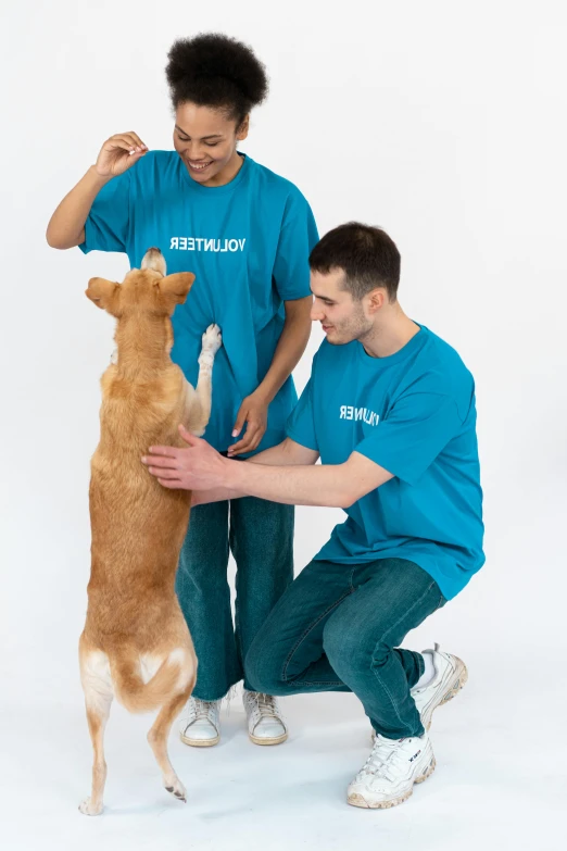 a couple of people that are playing with a dog, by Breyten Breytenbach, wearing shirts, official product photo, full-body, hey buddy