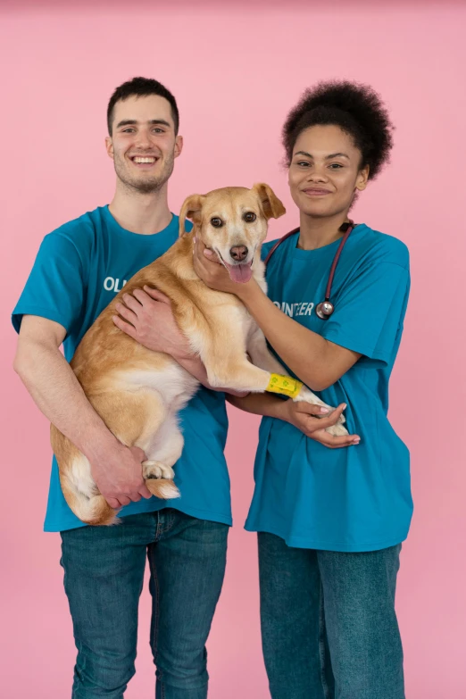 a couple of people that are holding a dog, cyan photographic backdrop, oliver cook, healthcare worker, modelling