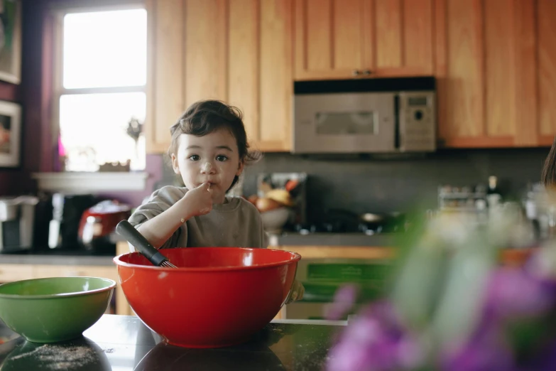 a little boy that is sitting in a bowl, pexels, kitchen counter, avatar image, square, mixing